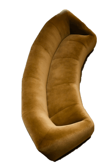 A contemporary, generously curved upholstered sofa in a light, neutral beige tone. The sofa features a continuous, rounded form with no visible legs, giving it a low-profile and substantial presence. The backrest and seat are seamlessly integrated, suggesting a cohesive, single-piece construction. The upholstery appears to be a textured fabric, possibly boucle or a fine-grained velvet, with subtle vertical seams segmenting the back and seat portions. Its design is minimalist, focusing on organic curves and comfort. — 3D model