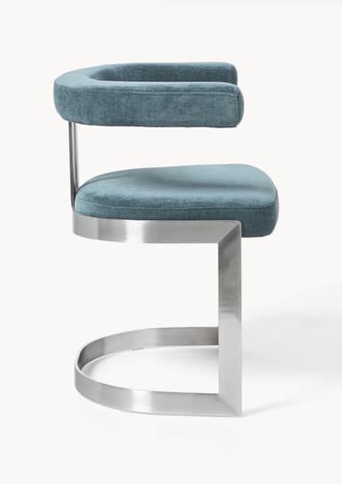 A modern armchair with a metal frame and upholstered seating. The armchair features a curved, open armrest design, a rectangular seat cushion, and a curved sled base. The frame appears to be made of polished metal, possibly stainless steel or aluminum, with a brushed finish. The upholstery is a textured fabric in a deep teal or blue-green hue. — 3D model