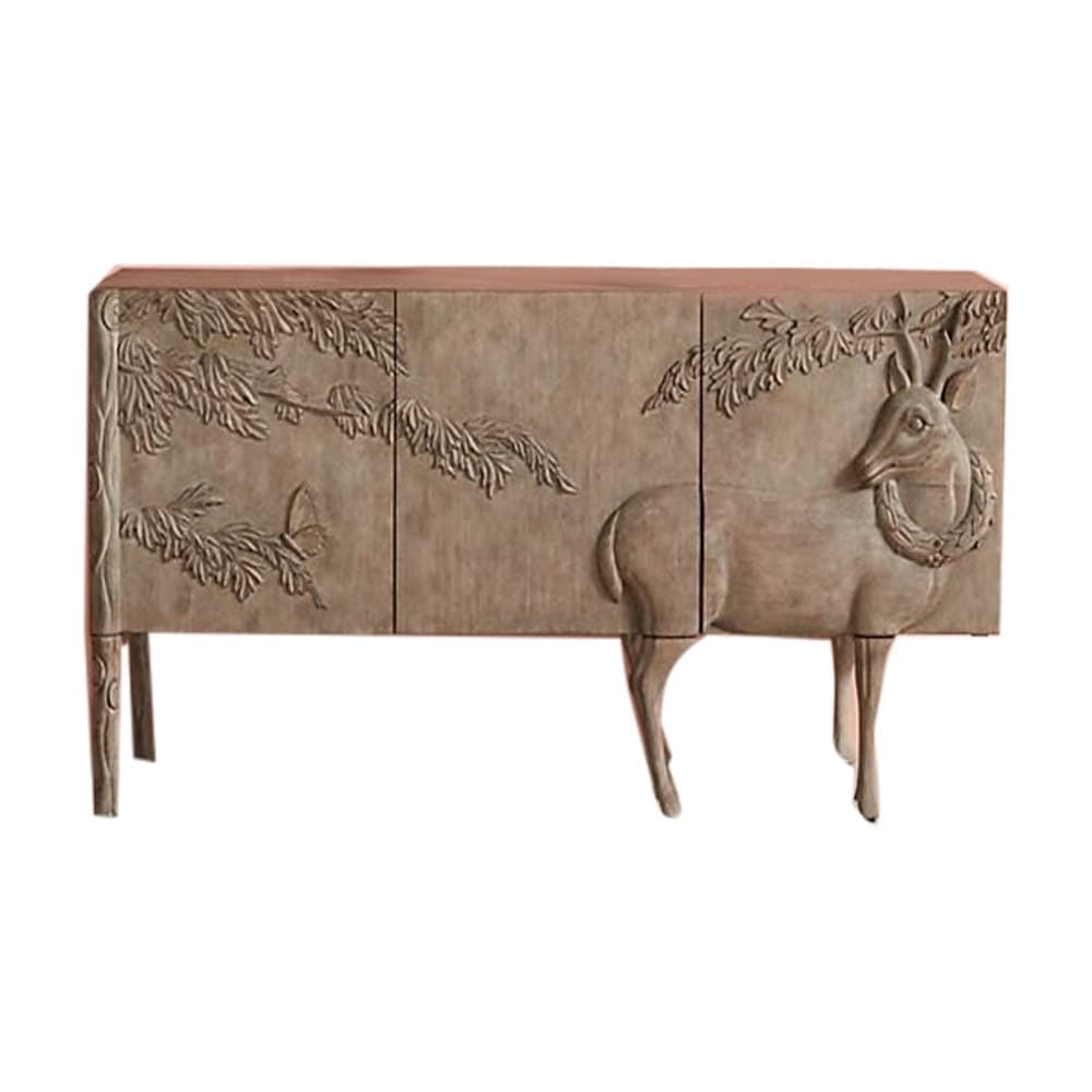 This is a carved wooden sideboard featuring intricate relief carvings of a deer with a wreath around its neck and foliage with butterflies. The cabinet has a rectangular form with four doors, supported by four tapered legs that extend from the cabinet body, with the front two legs designed to resemble the legs of the deer. The finish is a light, natural wood tone, enhancing the detailed carvings. — 3D model