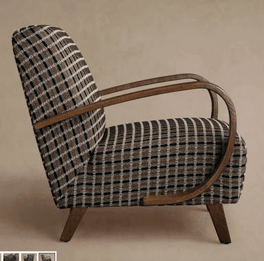 An upholstered armchair featuring a distinctive plaid pattern in dark brown, black, and cream, set against dark stained wooden arms and tapered legs. The design combines a classic aesthetic with modern lines, suitable for various interior settings. The wooden armrests exhibit a smooth, curved shape, providing a comfortable resting place. — 3D model