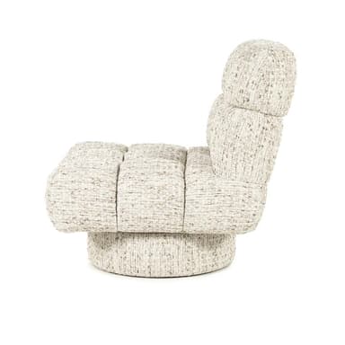 A cream-colored armchair with a plush, channel-tufted design. The chair features a low back and a wide, inviting seat. It is upholstered in a textured fabric with flecks of brown and grey. The base is a circular, swivel pedestal, also upholstered in the same fabric, providing stability and rotation. — 3D model