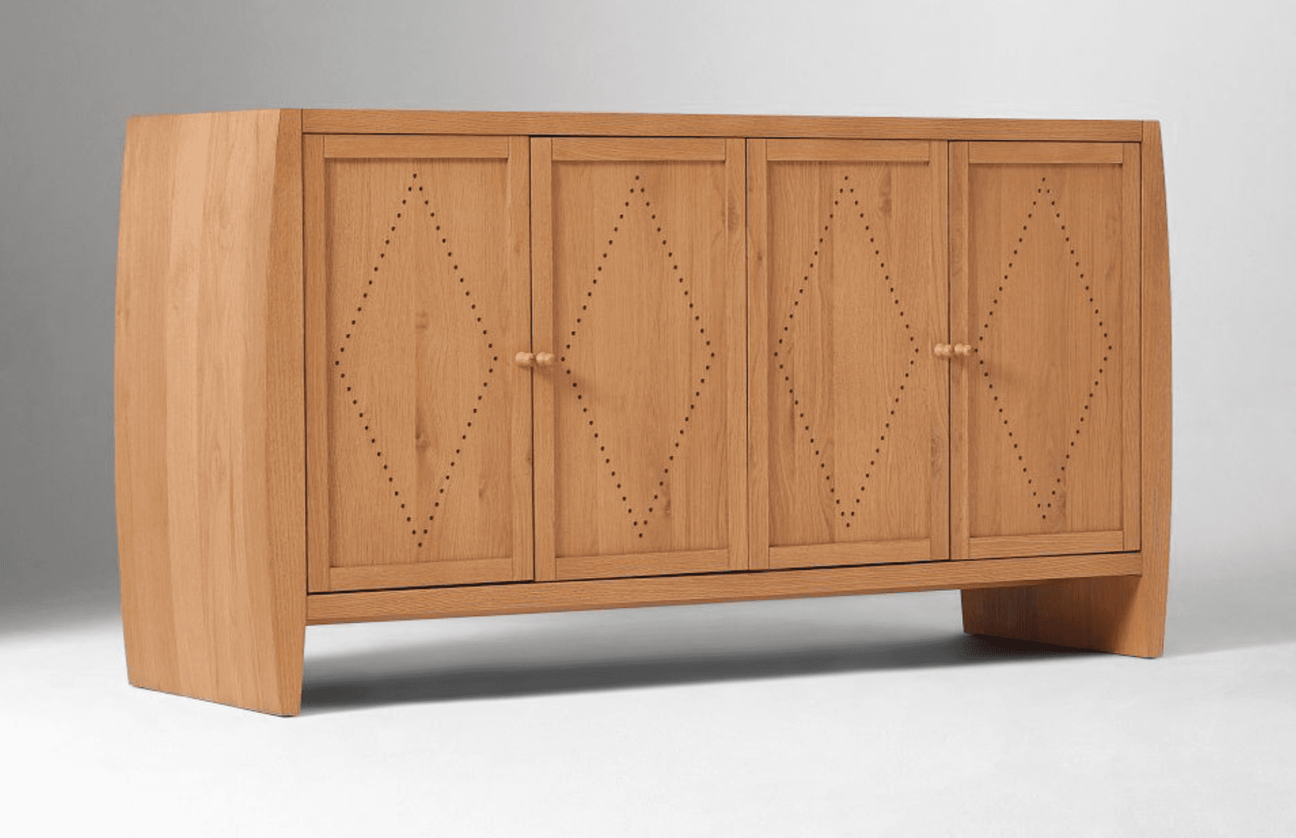 A four-door credenza made of light-colored wood, featuring a modern design with slightly curved side panels and geometric detailing on the doors. Each door is inset with a diamond pattern created by small perforations. The credenza has minimalist wooden knob handles and stands on angled wooden legs. — 3D model