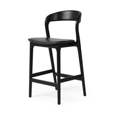 A contemporary bar stool with a black wooden frame and a dark upholstered seat. The stool features a gently curved backrest and a square footrest connecting the tapered legs. — 3D model