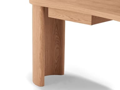 A modern wooden desk with a distinctive oval-shaped tabletop. It features two curved, cylindrical legs that provide support. A single, integrated drawer is subtly incorporated into the underside of the tabletop on one side, maintaining the clean, minimalist aesthetic. The wood grain is visible, suggesting a natural finish. — 3D model