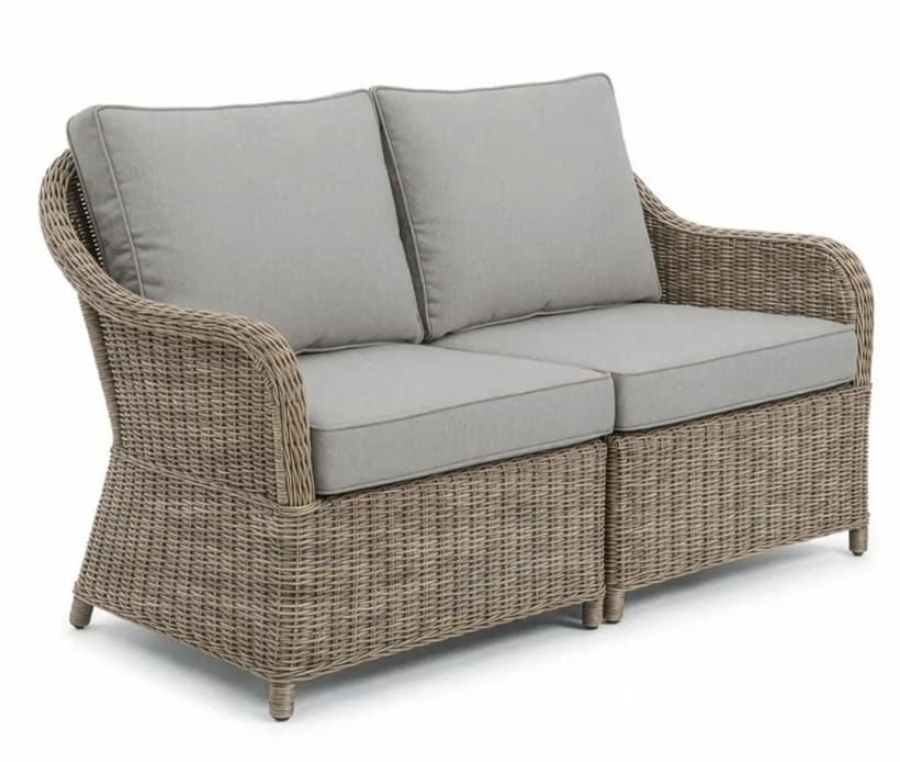 A two-seater sofa constructed with a woven wicker-like material for the base and arms, featuring upholstered cushions for the seat and backrest. The base is segmented into two distinct sections, suggesting modularity or a design choice for distinct seating areas. The arms are curved and flow smoothly into the backrest. The cushions are a light gray color with piping along the edges. — 3D model