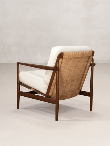 A mid-century modern lounge chair featuring a dark wooden frame and light-colored upholstered cushions. The design is characterized by clean lines and exposed joinery, with a slightly reclined posture for relaxation. — 3D model