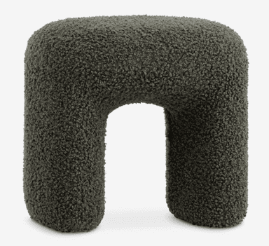 A contemporary U-shaped stool upholstered in a dark green boucle fabric. The stool features soft, rounded edges and a sculptural form, providing both a unique aesthetic and comfortable seating. Its entire surface is covered in the textured, looped yarn fabric. — 3D model