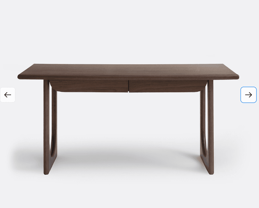 A wooden desk with a simple, modern design. It features a rectangular tabletop with slightly rounded edges and two drawers integrated into the front. The desk is supported by two curved legs on each side, creating an open base structure. The wood grain is visible, suggesting a natural wood finish. — 3D model
