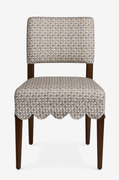 A traditional upholstered side chair featuring a scalloped fabric skirt and a small floral pattern. It has a fully upholstered seat and back, supported by dark wooden tapered legs. — 3D model