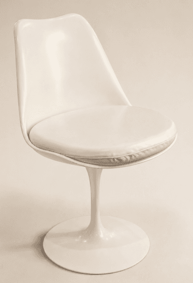 An off-white, armless dining chair featuring a molded fiberglass or plastic shell seat with an integrated, removable upholstered cushion, all supported by a distinctive single pedestal base that flares out to a circular footprint. — 3D model