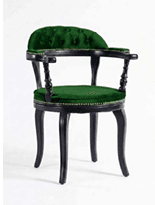 A traditional barrel-back armchair featuring a dark wooden frame and rich emerald green velvet upholstery. The curved backrest is deeply button-tufted, and the seat is also upholstered in velvet. The armrests are dark wood, turned, and supported by turned spindles, with decorative brass studding along the perimeter of the upholstery. The chair stands on four curved, dark wooden legs. — 3D model