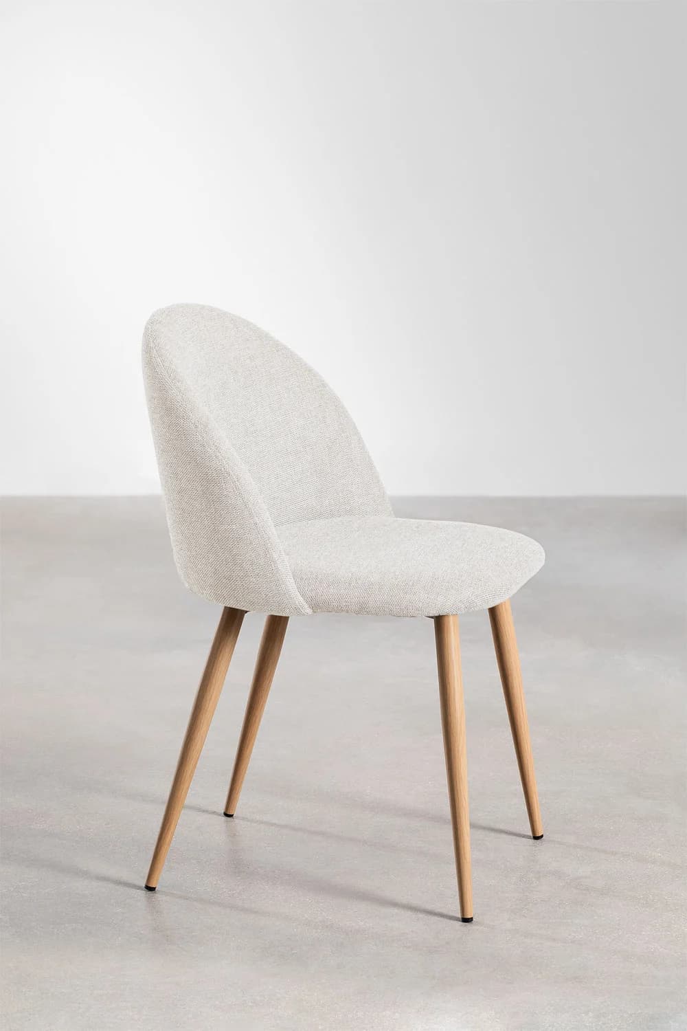 An armless side chair with a gently curved, upholstered backrest and seat, supported by four tapered wooden legs. — 3D model