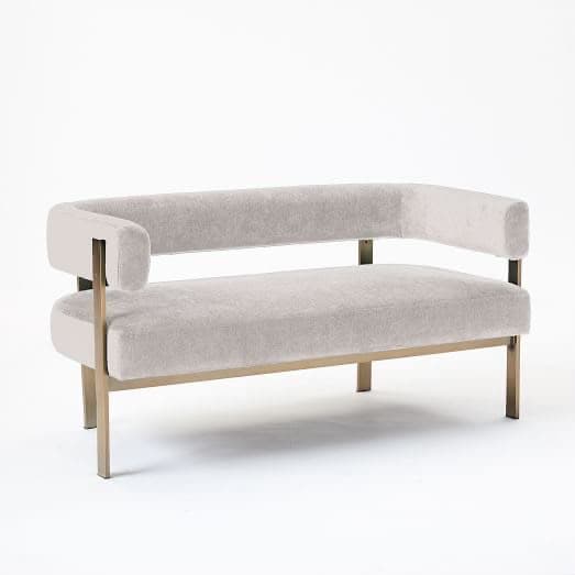 A contemporary loveseat featuring a light gray velvet upholstery and an exposed gold-tone metal frame. It has a rounded backrest that extends into armrests, providing a minimalist yet elegant profile. — 3D model