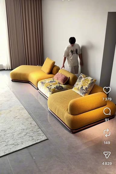 A multi-piece modular sectional sofa with curvilinear forms, upholstered in a mustard yellow fabric, featuring a low profile and patterned accent cushions. — 3D model