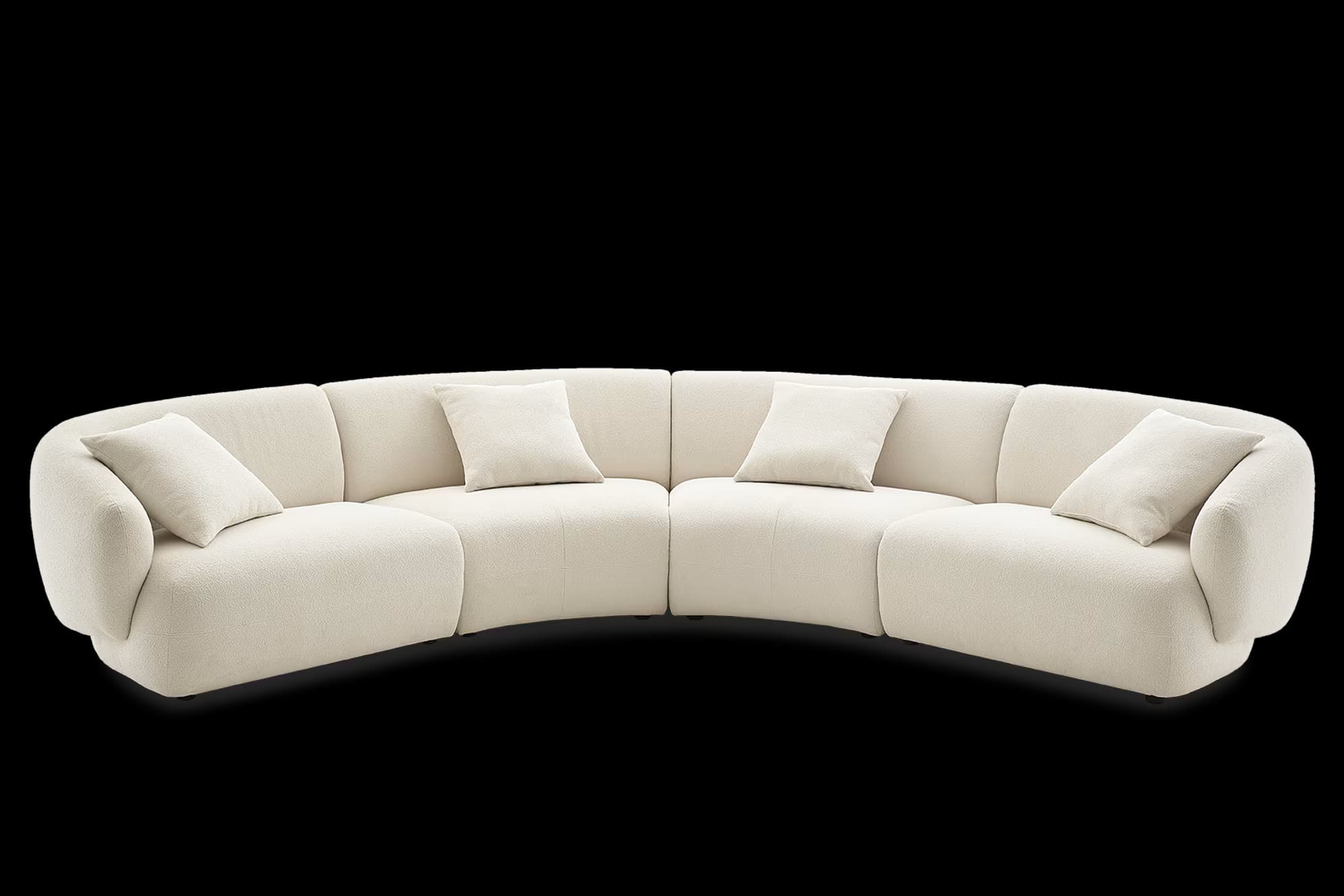 A large, multi-segment curved sectional sofa upholstered in a cream or off-white boucle fabric. The sofa features a continuous, gently curved form, comprising several modular sections. It has low-profile armrests and backrests that seamlessly blend into the overall soft, rounded design. Several matching square and rectangular throw pillows are distributed across its surface, enhancing comfort and visual appeal. The construction appears sturdy, with a solid base that keeps the sofa low to the ground. — 3D model