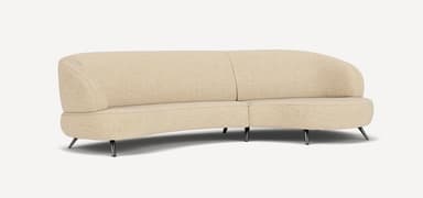 A modern curved sectional sofa, upholstered in a light beige or cream textured fabric, featuring a flowing, organic form and supported by slender, angled dark metal legs. — 3D model