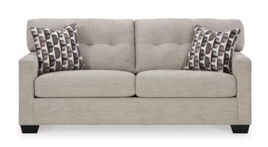 A contemporary upholstered sofa featuring a light beige or greige fabric, block arms, and tapered block feet. It has two large seat cushions and two back cushions with button tufting. Two patterned throw pillows are included. — 3D model
