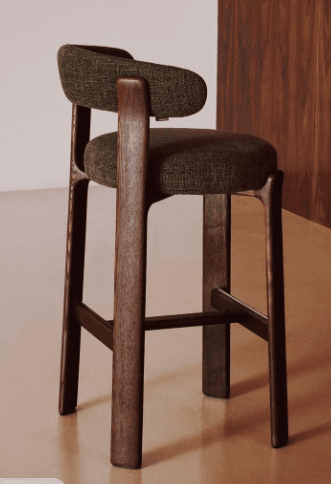 A modern bar stool with a wooden frame and an upholstered seat and backrest. The stool features curved armrests that blend into the backrest, and its legs are connected by stretchers for stability. The wooden components have a rich, dark finish, and the upholstery is a textured, dark green fabric. — 3D model