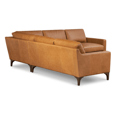 An L-shaped sectional sofa upholstered in tan or cognac-colored leather, featuring multiple seat and back cushions and supported by dark-finished, tapered wooden legs. — 3D model