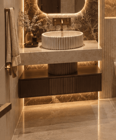 A modern wall-mounted bathroom vanity featuring a dark fluted wood cabinet, a beige marble countertop, and a matching fluted marble vessel sink, accompanied by a brass faucet. — 3D model