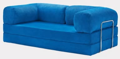 A vibrant blue modular floor sofa upholstered in corduroy fabric. The sofa features a multi-layered base, indicative of a convertible or modular design. It includes two cylindrical bolster cushions serving as backrests and a single bolster acting as an armrest, supported by a polished chrome metal frame on one side. The overall aesthetic is modern and casual. — 3D model