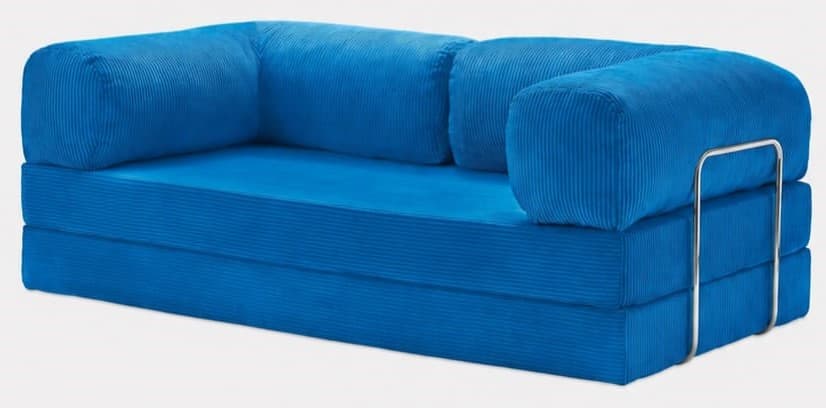A vibrant blue modular floor sofa upholstered in corduroy fabric. The sofa features a multi-layered base, indicative of a convertible or modular design. It includes two cylindrical bolster cushions serving as backrests and a single bolster acting as an armrest, supported by a polished chrome metal frame on one side. The overall aesthetic is modern and casual. — 3D model