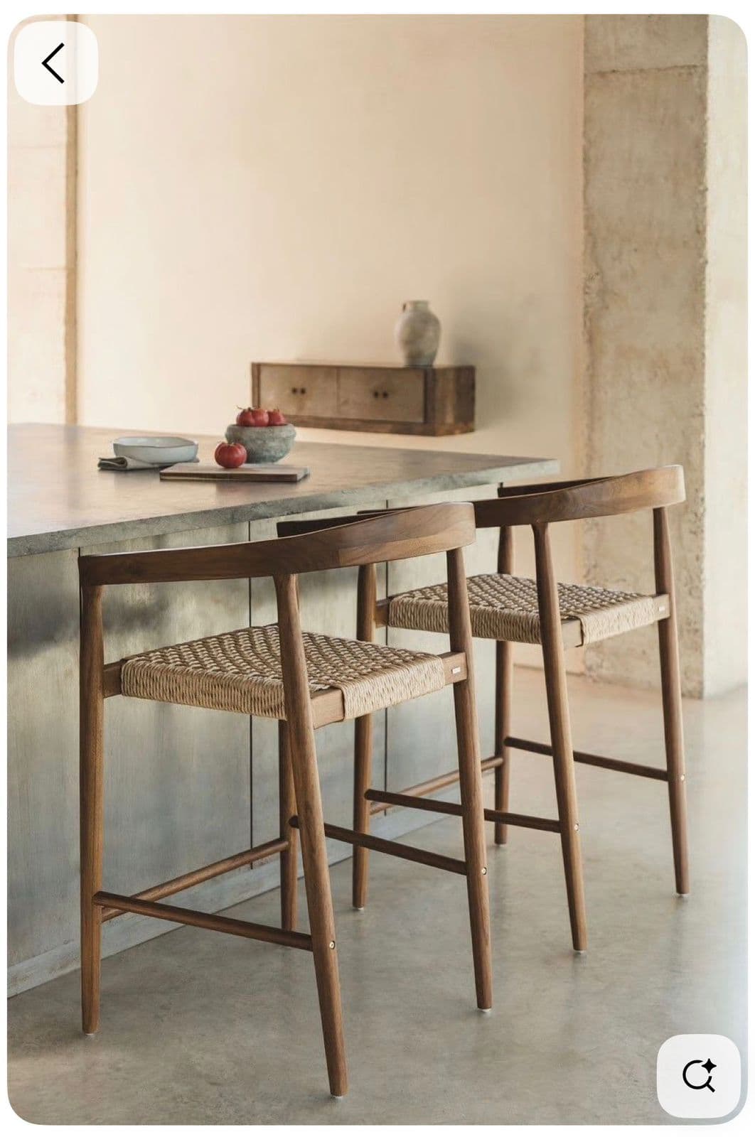 A wooden bar stool featuring a curved backrest and armrests, with a tightly woven natural cord seat and slender wooden legs. — 3D model