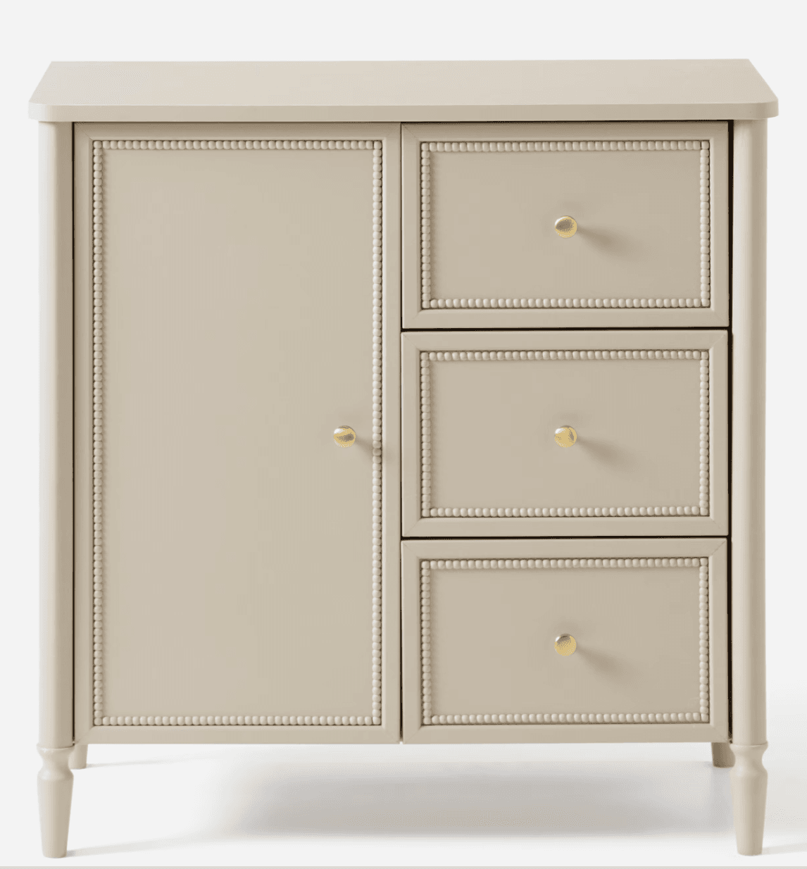 A compact, light beige storage unit featuring a cabinet door on the left and three stacked drawers on the right, all adorned with decorative beaded trim and brass knob hardware. It stands on four tapered, turned legs. — 3D model