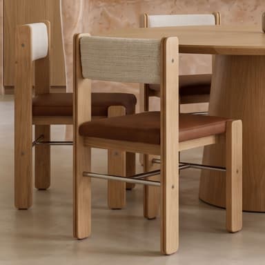 A contemporary armless chair featuring a light natural oak wood frame, a rectangular brown upholstered seat, and a light off-white woven fabric backrest. The design includes polished metal crossbars between the legs for added stability and a minimalist aesthetic. — 3D model
