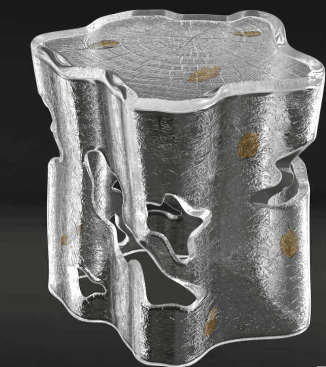 A sculptural accent table or stool crafted from clear, textured resin, designed to resemble a block of ice or a natural tree stump. The piece features an organic, irregular silhouette with cut-out sections in its body, giving it a light, ethereal appearance. Embedded within the clear material are small, delicate golden leaf inclusions. The top surface is flat but textured with an embossed wood grain pattern, suggesting tree rings, further enhancing its nature-inspired aesthetic. The overall impression is one of modern artistry combined with natural elements. — 3D model