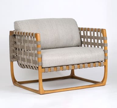 A modern lounge chair featuring a natural wood frame, woven strap detailing on the arms and back, and thick, light grey upholstered cushions. — 3D model