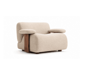 A modern upholstered armchair featuring soft, rounded contours and distinctive sculptural wooden elements. The chair is covered in a light beige, textured fabric, likely boucle, and includes separate rounded armrest cushions that rest on a vertical, dark wood panel. The overall aesthetic is plush and contemporary, supported by small, rounded wooden feet. — 3D model