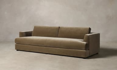 A contemporary sofa with a plush, textured upholstery. It features a low-profile rectangular base, straight arms that curve slightly outwards at the top, and a deep seat cushion. The backrest is divided into two distinct rectangular cushions, providing ample seating space. The overall design is minimalist and modern, with clean lines and a focus on comfort and material. — 3D model