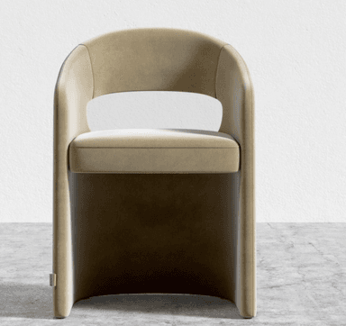 A contemporary armchair with a solid, curved back that extends to form the armrests. The seat is upholstered and slightly recessed within the structure. The base is integrated into the main body of the chair, creating a substantial and modern silhouette. — 3D model