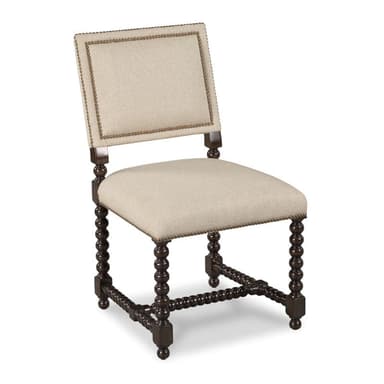 An armless side chair with a dark bobbin-turned wooden frame and light beige upholstered seat and back, accented with nailhead trim. — 3D model