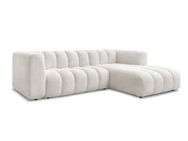 A white, modular sectional sofa with a chaise lounge extension. The sofa features a distinctive channel-tufted design on its seat cushions, backrests, and chaise. The upholstery appears to be a textured boucle fabric. The sofa has a low profile with concealed legs, giving it a contemporary aesthetic. — 3D model