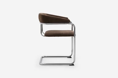 A modern armchair featuring a cantilevered tubular chrome frame and dark brown fabric upholstery. The seat and backrest are integrated, with the back curving upwards and outwards to form armrests. — 3D model