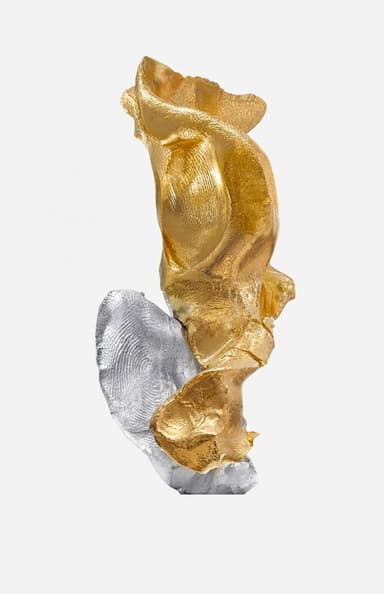 An abstract, biomorphic sculpture composed of two distinct, organically shaped elements. The top element is finished in a lustrous gold, while the bottom element is finished in a contrasting silver. Both sections feature textured, undulating surfaces that suggest a fluid, molten or cast metal form. The two pieces appear to be interlocked or balanced precariously, creating a dynamic and visually intriguing composition. The gold element shows visible fingerprint-like textures, adding to its unique character. — 3D model