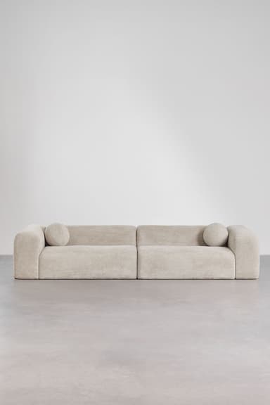 A contemporary, low-profile modular sofa upholstered in a light cream textured fabric, featuring soft, rounded edges and a minimalist design. — 3D model