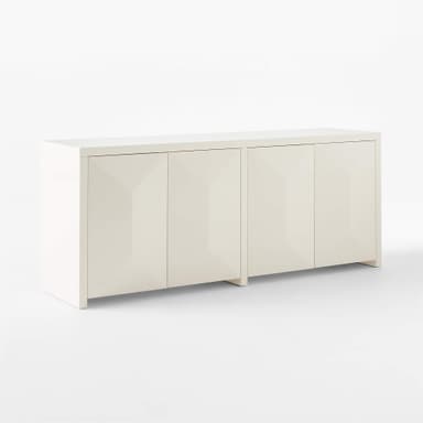 A white sideboard with a geometric, faceted design on its four doors. The doors are aligned in two pairs, creating a symmetrical facade. The sideboard has a clean, modern aesthetic with a simple rectangular silhouette and is supported by short, blocky feet. — 3D model