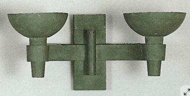 A double-headed sconce designed for wall mounting. It features two outward-facing, bowl-shaped light fixtures attached to a central rectangular backplate via a horizontal arm. The overall construction appears to be made of a textured, possibly metal or composite material with a matte green finish. — 3D model