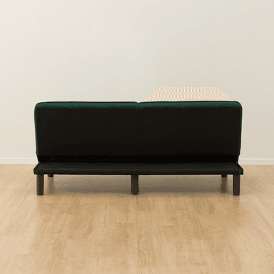 A dark emerald green velvet futon sofa bed with button tufting on the backrest and seat, supported by tapered wooden legs. — 3D model