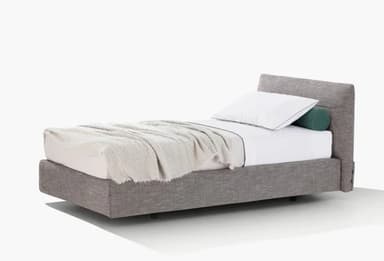A modern upholstered platform twin bed featuring a minimalist design. The bed frame and integrated headboard are covered in a textured gray fabric. It is made up with white bedding, a light gray throw blanket, a standard white pillow with black piping, and a cylindrical green bolster pillow. — 3D model