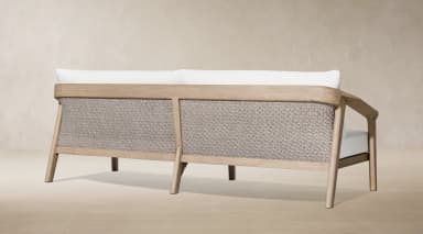 A modern outdoor two-seater sofa featuring a sturdy, light-toned wooden frame and plush white upholstered cushions for both seat and back. — 3D model