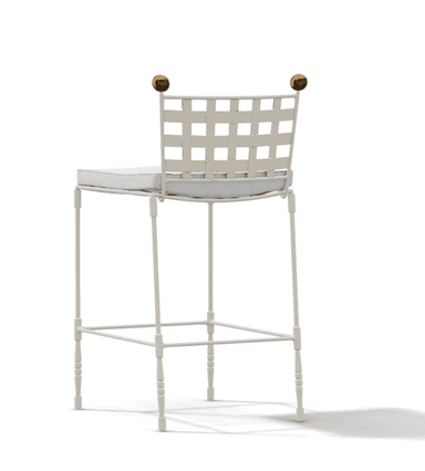 A white bar stool featuring a backrest constructed from wide interwoven straps, a cushioned seat, and decorative brass finials on the back posts. The frame is slender and includes an integrated footrest. — 3D model