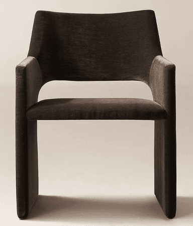 A dark brown fully upholstered armchair featuring a modern, monolithic design. The chair has a wide, slightly curved backrest, integrated armrests, and a sturdy, block-like base, all seamlessly covered in a plush, velvet-like fabric. — 3D model