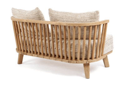 A two-seater sofa constructed with a light-colored wooden frame. The frame features slatted detailing along the base and turned spindle-style supports for the backrest. It is upholstered with a textured, light beige fabric on the seat and includes two matching throw pillows. — 3D model