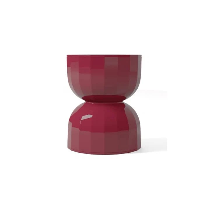 A modern, hourglass-shaped stool or side table rendered in a glossy, deep red finish. The surface features a distinct faceted or geometric pattern, giving it a sculptural appearance. The object is composed of two symmetrical bowl-like sections, meeting at a narrower waist in the middle, and appears to be made from a molded material like polycarbonate. — 3D model