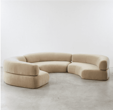 A large, modular sectional sofa with multiple curved sections, upholstered in a light beige velvet fabric, designed for flexible arrangement in a contemporary setting. — 3D model