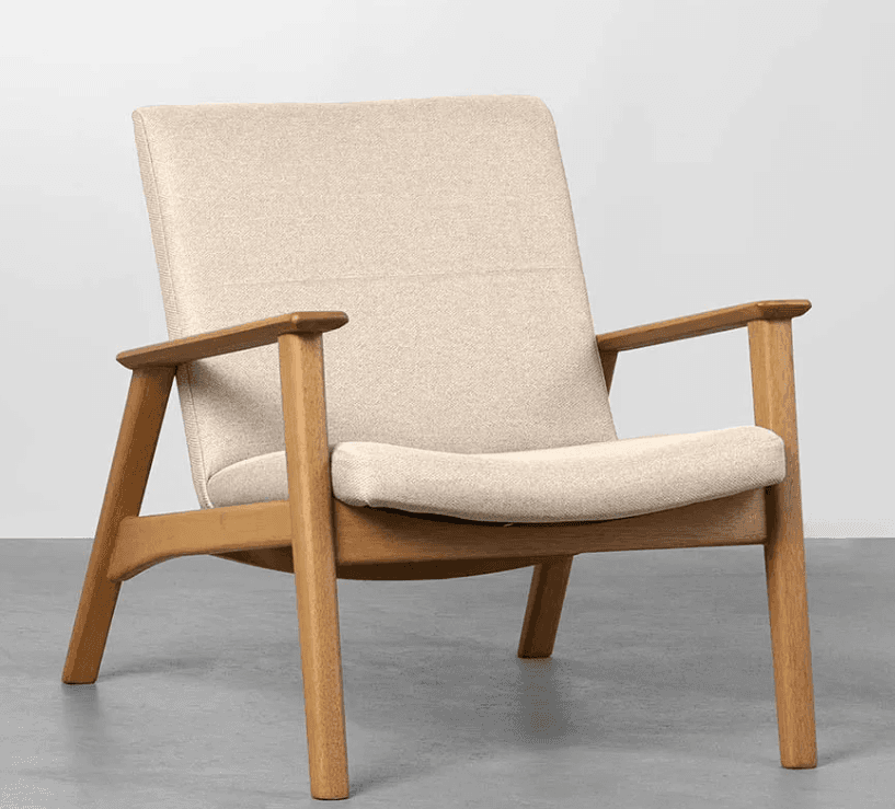 A modern armchair with a light-colored upholstered seat, back, and armrests, supported by a wooden frame. The frame features angled legs and a minimalist design. — 3D model